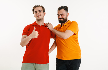 Image showing Young men weared in LGBT flag colors isolated on white background, LGBT pride concept