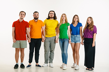 Image showing Young people weared in LGBT flag colors isolated on white background, LGBT pride concept