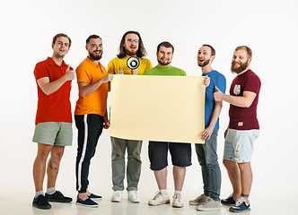 Image showing Young men weared in LGBT flag colors isolated on white background, LGBT pride concept