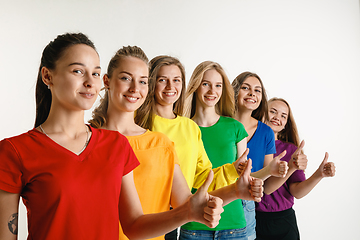 Image showing Young women weared in LGBT flag colors isolated on white background, LGBT pride concept