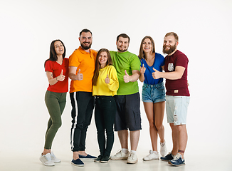 Image showing Young people weared in LGBT flag colors isolated on white background, LGBT pride concept