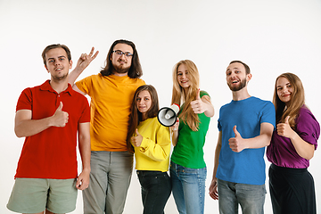 Image showing Young people weared in LGBT flag colors isolated on white background, LGBT pride concept