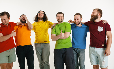 Image showing Young men weared in LGBT flag colors isolated on white background, LGBT pride concept