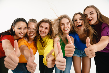 Image showing Young women weared in LGBT flag colors isolated on white background, LGBT pride concept