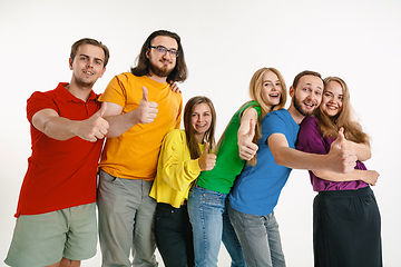 Image showing Young people weared in LGBT flag colors isolated on white background, LGBT pride concept