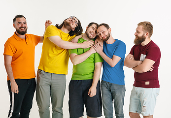 Image showing Young men weared in LGBT flag colors isolated on white background, LGBT pride concept