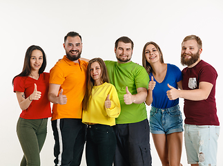 Image showing Young people weared in LGBT flag colors isolated on white background, LGBT pride concept