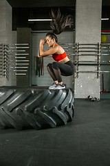 Image showing A muscular female athlete doing workout at the gym