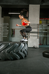 Image showing A muscular female athlete doing workout at the gym