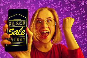 Image showing Portrait of woman showing screen of mobile phone, black friday