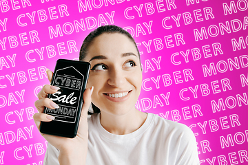 Image showing Portrait of woman showing screen of mobile phone, black friday