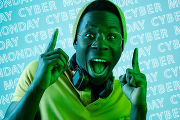 Image showing Portrait of young man on blue background, black friday