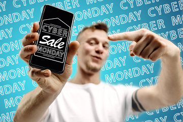 Image showing Portrait of man showing screen of mobile phone, black friday