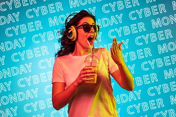 Image showing Portrait of young woman on blue background, black friday