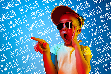 Image showing Portrait of little girl on blue background, black friday