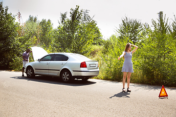 Image showing Young multiethnic international couple traveling on the car in sunny day