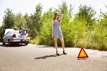 Image showing Young multiethnic international couple traveling on the car in sunny day