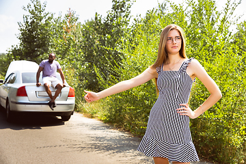 Image showing Young multiethnic international couple traveling on the car in sunny day