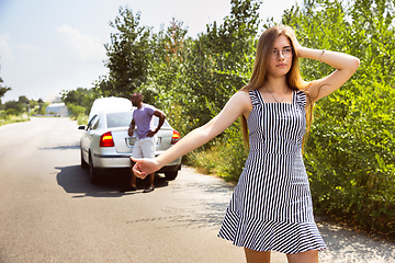 Image showing Young multiethnic international couple traveling on the car in sunny day