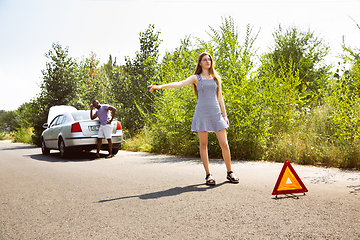 Image showing Young multiethnic international couple traveling on the car in sunny day