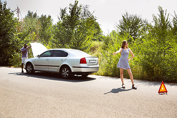 Image showing Young multiethnic international couple traveling on the car in sunny day