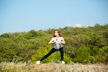 Image showing Beautiful young woman training flexibility outdoors