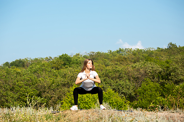 Image showing Beautiful young woman training flexibility outdoors