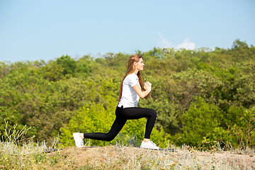 Image showing Beautiful young woman training flexibility outdoors