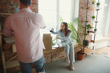 Image showing Young couple moved to a new house or apartment