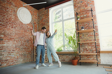 Image showing Young couple moved to a new house or apartment