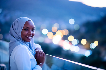 Image showing African  modern Muslim woman in night at balcony