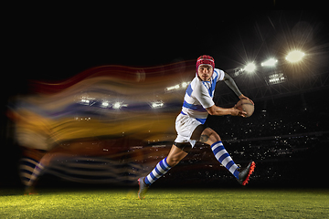 Image showing One caucasian man playing rugby on the stadium in mixed light