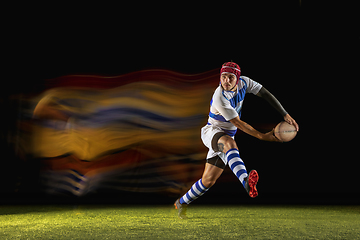 Image showing One caucasian man playing rugby on the stadium in mixed light