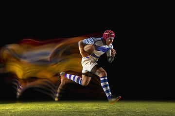 Image showing One caucasian man playing rugby on the stadium in mixed light
