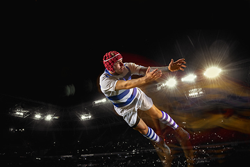 Image showing One caucasian man playing rugby on the stadium in mixed light