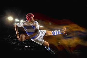 Image showing One caucasian man playing rugby on the stadium in mixed light