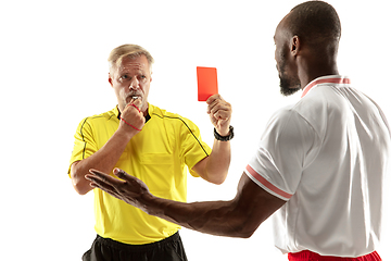 Image showing Football referee showing a red card to a displeased player isolated on white background