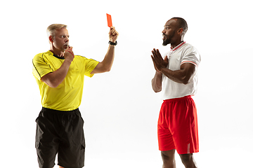 Image showing Football referee showing a red card to a displeased player isolated on white background