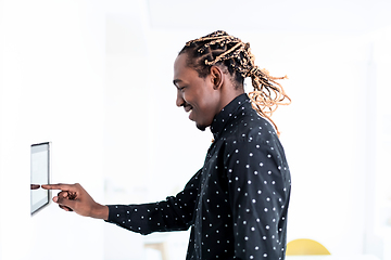 Image showing African man using smart home screen