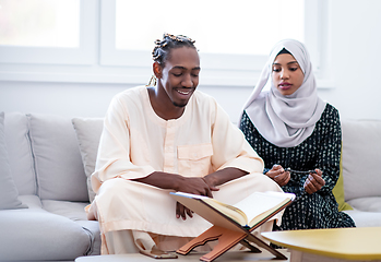 Image showing african couple at home reading quran