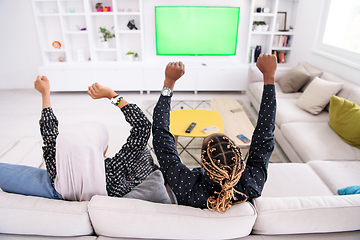 Image showing African Couple Sitting On Sofa Watching TV Together