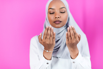 Image showing African Muslim woman makes traditional prayer to God