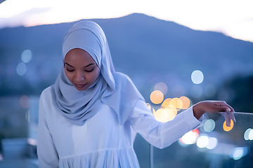 Image showing African  modern Muslim woman in night at balcony