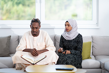 Image showing african couple at home reading quran