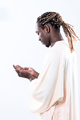 Image showing african man pray to Allah