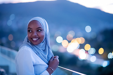 Image showing African  modern Muslim woman in night at balcony