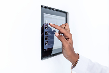 Image showing african woman using smart home screen