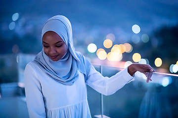 Image showing African  modern Muslim woman in night at balcony