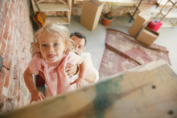 Image showing Young father and his daughter moved to a new house or apartment