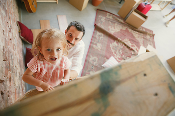 Image showing Young father and his daughter moved to a new house or apartment